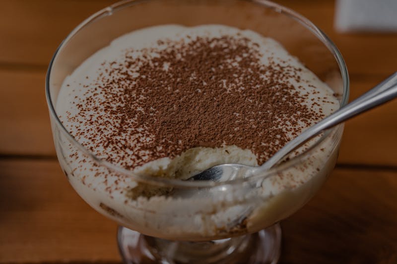 Classic Italian tiramisu dessert with cocoa dusting