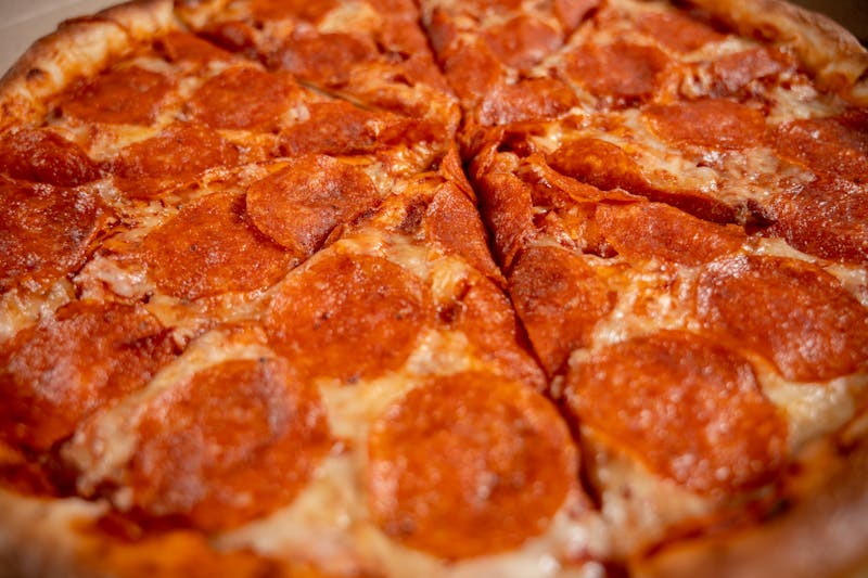Meat lovers thin crust pizza with pepperoni sausage and ham
